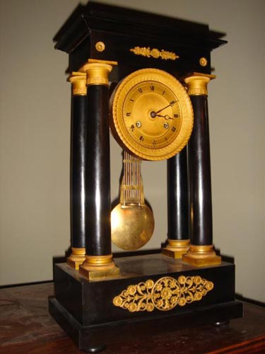 French ebony ormolu empire portico clock