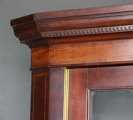 A 19thC mahogany corner cupboard, with moulded top and cross
